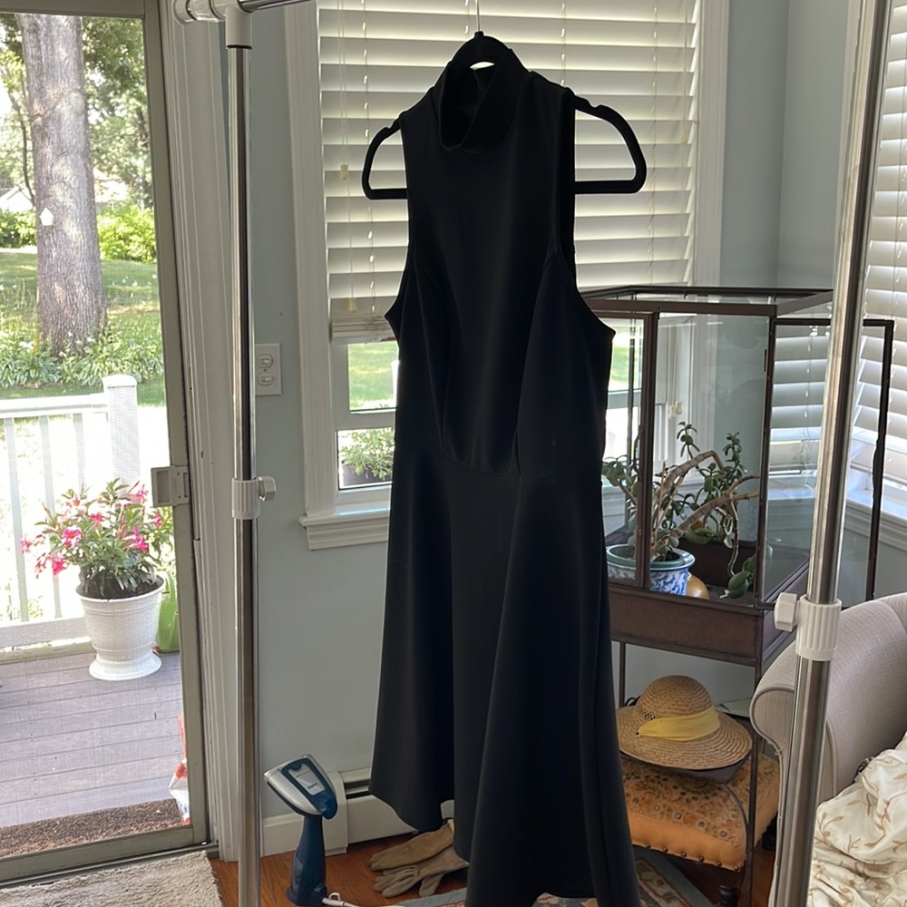 High neck, black zip back, dress size M.